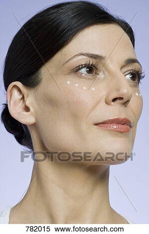 Stock Photography - A woman with moisturizer on her face. Fotosearch