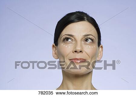 Portrait of a woman applying moisturizer View Large Photo Image Stock Photography - Portrait of a woman applying moisturizer. Fotosearch