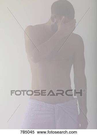 A man covering his face while wrapped in a towel View Large Photo Image Stock Photography - A man covering his face while wrapped in a towel. Fotosearch