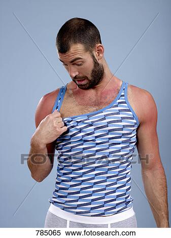 A man looking at his sunburned chest View Large Photo Image Stock Photography - A man looking at his sunburned chest. Fotosearch