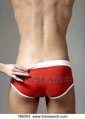 A woman's hand pulling on a man's underpants View Large Photo Image Picture - A woman's hand pulling on a man's underpants. Fotosearch