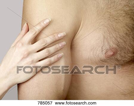 A woman's hand touching a man's arm View Large Photo Image Stock Photo - A woman's hand touching a man's arm. Fotosearch
