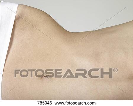 Midsection of a woman lying on her side View Large Photo Image Stock Photograph - Midsection of a woman lying on her side. Fotosearch