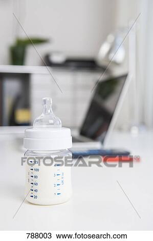 A baby's bottle on an office desk View Large Photo Image Stock Image - A baby's bottle on an office desk. Fotosearch