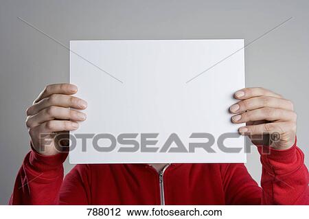 A man holding a blank sheet of paper View Large Photo Image Stock Image - A man holding a blank sheet of paper. Fotosearch