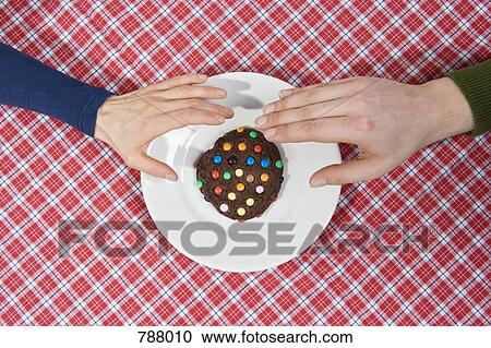 Two hands reaching for a cookie View Large Photo Image Stock Image - Two hands reaching for a cookie. Fotosearch