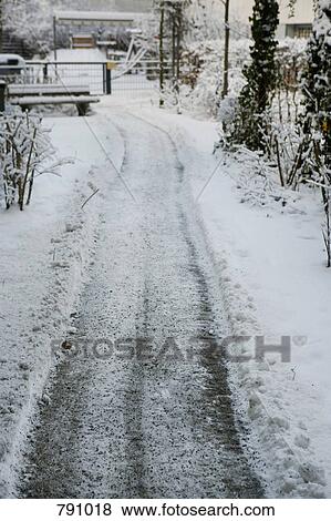 A cleared pathway leading to a snowy park, Berlin, Germany View Large Photo Image Stock Photo - A cleared pathway leading to a snowy park, Berlin, Germany. Fotosearch