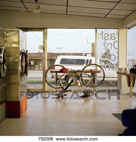A bike upside down in a laundromat View Large Photo Image Stock Photograph - A bike upside down in a laundromat. Fotosearch