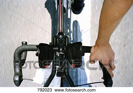 High angle view of a cyclist riding a bike View Large Photo Image Stock Image - High angle view of a cyclist riding a bike. Fotosearch