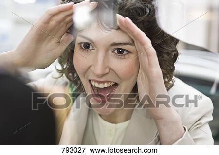 A woman looking with excitement through a store window View Large Photo Image Stock Photo - A woman looking with excitement through a store window. Fotosearch