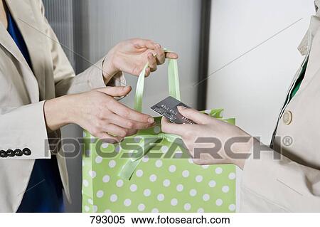 A woman paying by credit card View Large Photo Image Stock Photography - A woman paying by credit card. Fotosearch