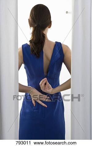 A woman trying on a dress View Large Photo Image Stock Image - A woman trying on a dress. Fotosearch