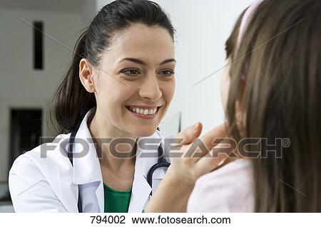 A doctor examining a girl's glands View Large Photo Image Stock Image - A doctor examining a girl's glands. Fotosearch