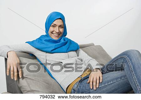 Portrait of a woman wearing a Hijab and jeans View Large Photo Image Stock Image - Portrait of a woman wearing a Hijab and jeans. Fotosearch