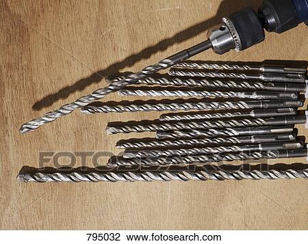 A drill and assorted drill bits on a bench View Large Photo Image Stock Image - A drill and assorted drill bits on a bench. Fotosearch