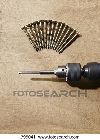 A drill and screws arranged on a bench View Large Photo Image Stock Image - A drill and screws arranged on a bench. Fotosearch