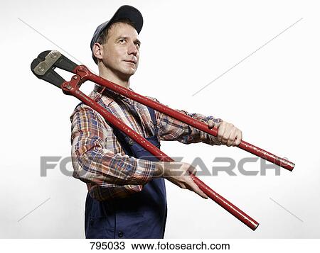 A man holding bolt cutters over his shoulder View Large Photo Image Stock Image - A man holding bolt cutters over his shoulder. Fotosearch