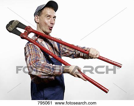 A man holding bolt cutters View Large Photo Image Stock Image - A man holding bolt cutters. Fotosearch