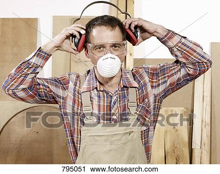 A man putting on protective workwear View Large Photo Image Stock Image - A man putting on protective workwear. Fotosearch