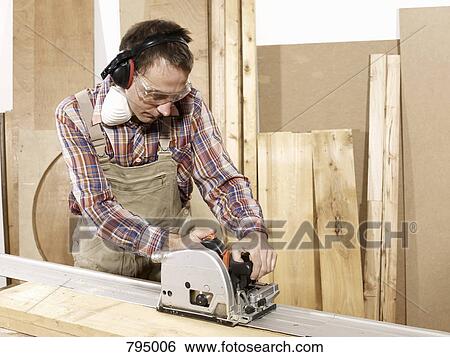A man using a circular saw View Large Photo Image Stock Photograph - A man using a circular saw. Fotosearch