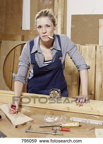 A woman smoking while working in a wood workshop View Large Photo Image Stock Photo - A woman smoking while working in a wood workshop. Fotosearch