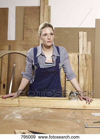 A woman standing in a wood workshop View Large Photo Image Stock Photo - A woman standing in a wood workshop. Fotosearch