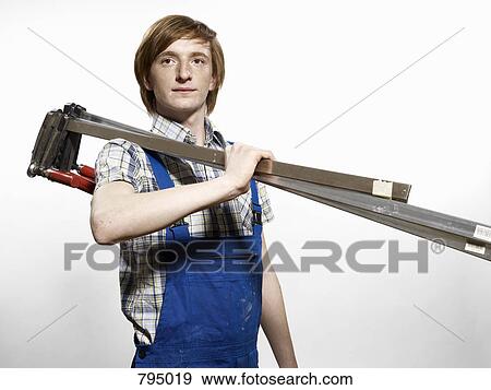 A young man holding calipers View Large Photo Image Stock Photo - A young man holding calipers. Fotosearch