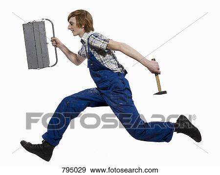A young man running with a toolbox and hammer View Large Photo Image Stock Photo - A young man running with a toolbox and hammer. Fotosearch