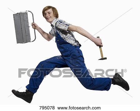 A young man running with a toolbox and hammer View Large Photo Image Stock Photo - A young man running with a toolbox and hammer. Fotosearch