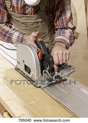 Detail of a man cutting wood with a rotary saw View Large Photo Image Stock Image - Detail of a man cutting wood with a rotary saw. Fotosearch