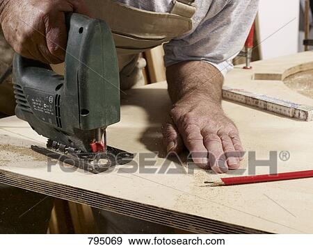 Detail of a man using a jigsaw View Large Photo Image Stock Photo - Detail of a man using a jigsaw. Fotosearch