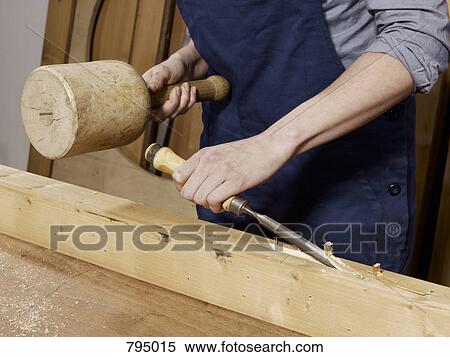 Stock Photography - Detail of a woman chiseling wood. Fotosearch