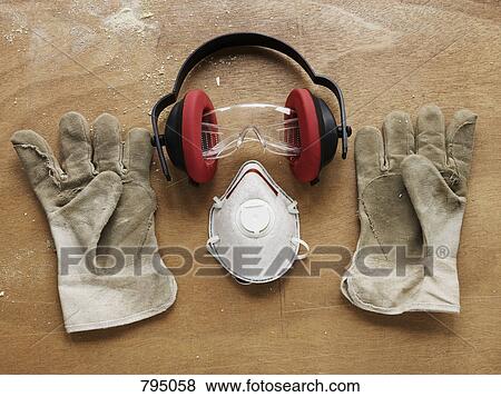 Protective workwear arranged on a bench View Large Photo Image Stock Photo - Protective workwear arranged on a bench. Fotosearch