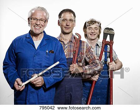 Three manual workers holding tools View Large Photo Image Stock Image - Three manual workers holding tools. Fotosearch