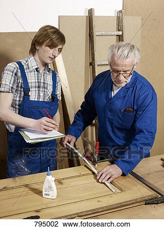 Two men working in a wood workshop View Large Photo Image Stock Image - Two men working in a wood workshop. Fotosearch
