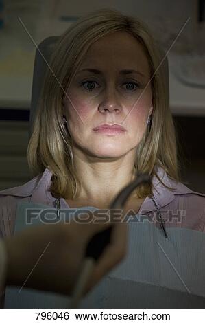 An anxious patient sitting in a dentist's chair View Large Photo Image Stock Photograph - An anxious patient sitting in a dentist's chair. Fotosearch