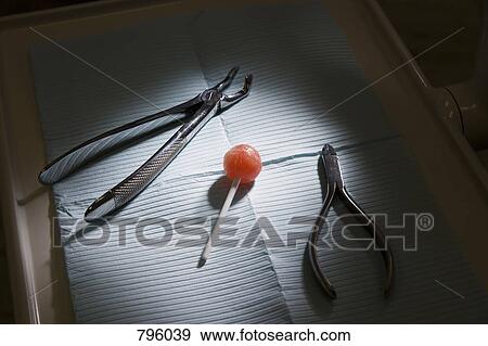 Dental instruments and a lollipop on a dental tray View Large Photo Image Stock Photo - Dental instruments and a lollipop on a dental tray. Fotosearch