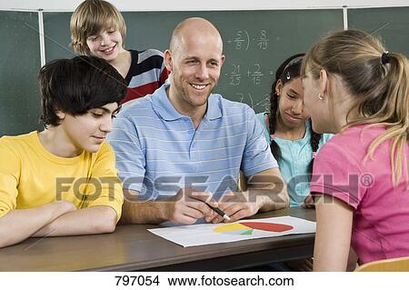 Picture - A teacher discussing a graph with students. Fotosearch