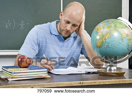 A teacher working at a desk View Large Photo Image Stock Photo - A teacher working at a desk. Fotosearch
