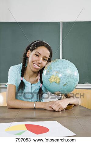 Portrait of a schoolgirl with her arms around a globe View Large Photo Image Stock Image - Portrait of a schoolgirl with her arms around a globe. Fotosearch