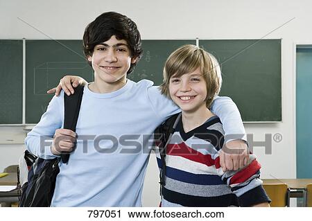 Stock Image - School friends standing side by side. Fotosearch