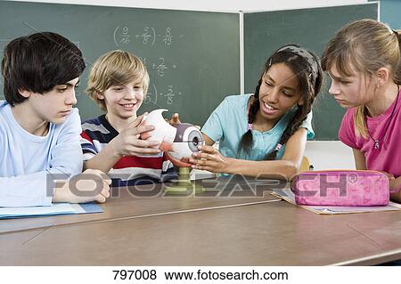 School students looking at a model of a human eye View Large Photo Image Stock Photo - School students looking at a model of a human eye. Fotosearch