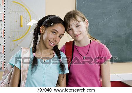 Two schoolgirls side by side View Large Photo Image Stock Image - Two schoolgirls side by side. Fotosearch