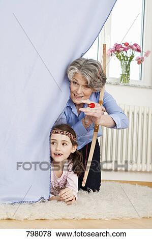A grandmother and her granddaughter playing make believe View Large Photo Image Stock Photo - A grandmother and her granddaughter playing make believe. Fotosearch
