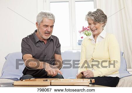 A senior man and a senior woman playing backgammon View Large Photo Image Stock Photo - A senior man and a senior woman playing backgammon. Fotosearch