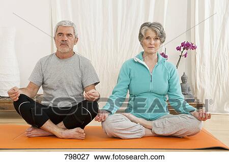 A senior man and senior woman doing yoga View Large Photo Image Stock Photo - A senior man and senior woman doing yoga. Fotosearch