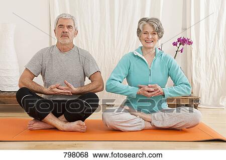 A senior man and senior woman doing yoga View Large Photo Image Stock Photo - A senior man and senior woman doing yoga. Fotosearch