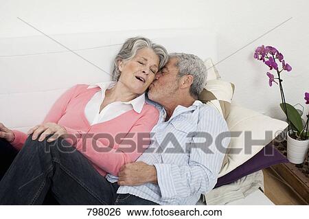 A senior man and senior woman lying on a couch together View Large Photo Image Stock Photograph - A senior man and senior woman lying on a couch together. Fotosearch