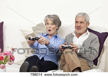 A senior man and senior woman playing a video game View Large Photo Image Picture - A senior man and senior woman playing a video game. Fotosearch
