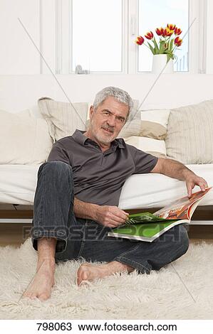 A senior man relaxing with a book View Large Photo Image Stock Image - A senior man relaxing with a book. Fotosearch